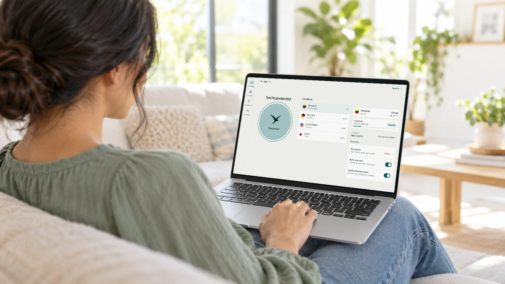 A woman on a sofa using Teal VPN on her Chromebook: You’re protected, Lithuania, the locations list and the protection switches